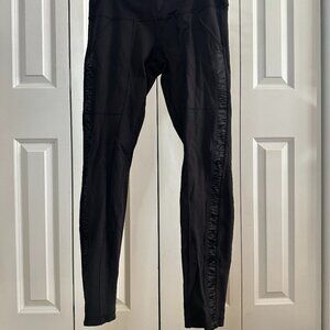 Lululemon size 10 black leggings with satin detail along legs